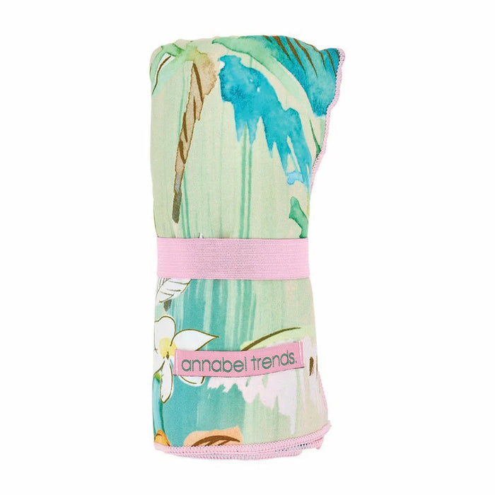 Sand free Tiki towel rolled up with elastic strap - compact and lightweight for travel
