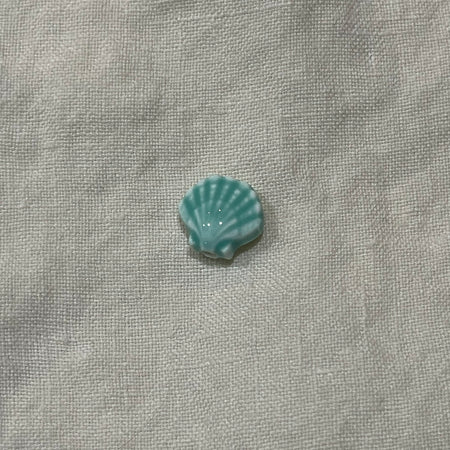 Seafoam aqua ceramic scallop shell bead on white linen - Travel and Tide Coastal Notions
