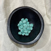 Seafoam aqua ceramic scallop shell beads in a dark bowl - Travel and Tide Coastal Notions

