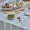 Seychelles brass fish bottle opener with enamel handle detailing styled on a coastal kitchen bench