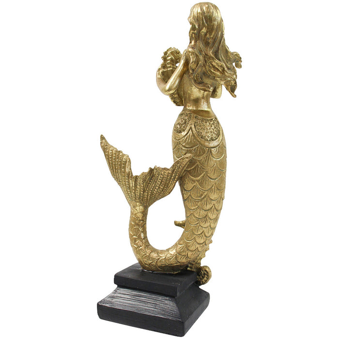 Gold resin standing mermaid sculpture back view showing flowing hair detail and scaled tail on dark base
