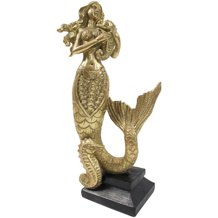 Gold resin standing mermaid sculpture holding seahorse with detailed scale tail and dark timber base
