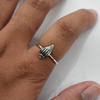 Sterling silver conch shell ring worn on hand, showing scale and fit of the oxidised shell detail on slim band

