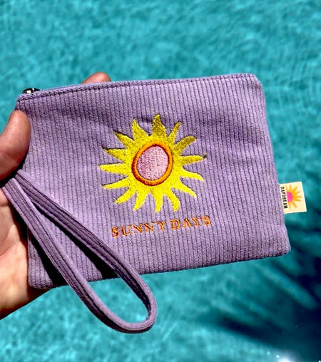 Close-up of Sunny Days sun embroidery detail on soft lavender corduroy wristlet pouch by Daydream Prints
