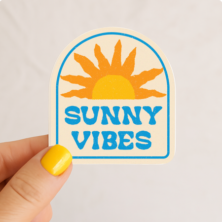 Sunny Vibes retro sunburst vinyl sticker with bold blue lettering and golden sun design — waterproof coastal decal by Daydream Prints
